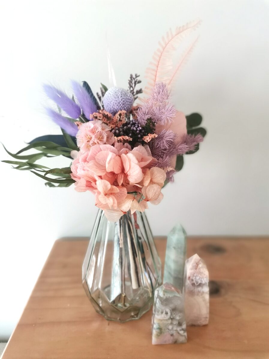 pretty-feminine-coloured-dried-flowers-in-a-faceted-glass-vase